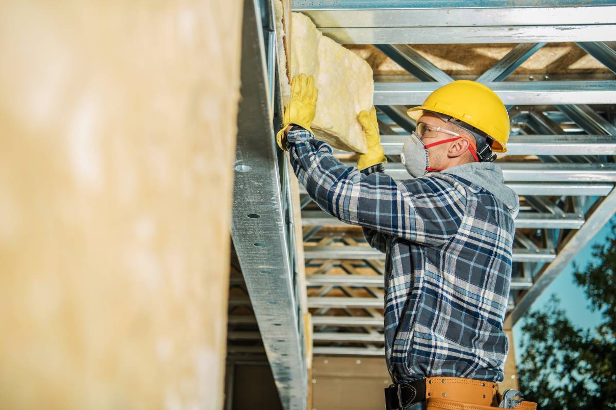 Wall Insulation Installation by Professional Construction Worker. Mineral Wool House Insulator.